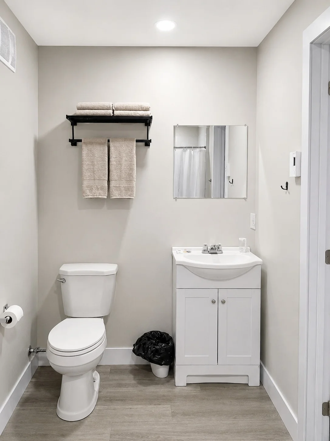 Suite bathroom with vanity, toilet and towel rack