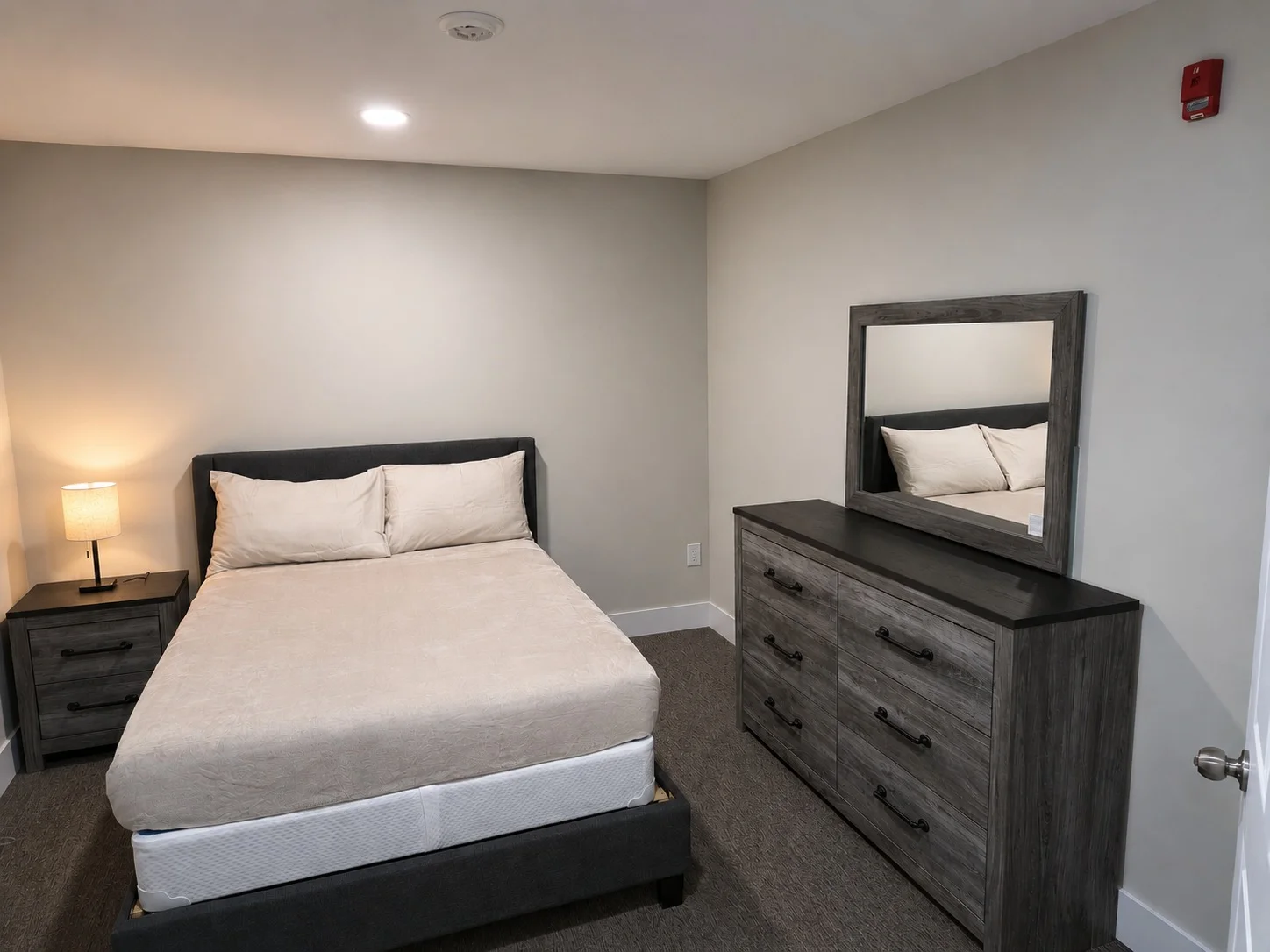 Suite bedroom with lamp and dresser