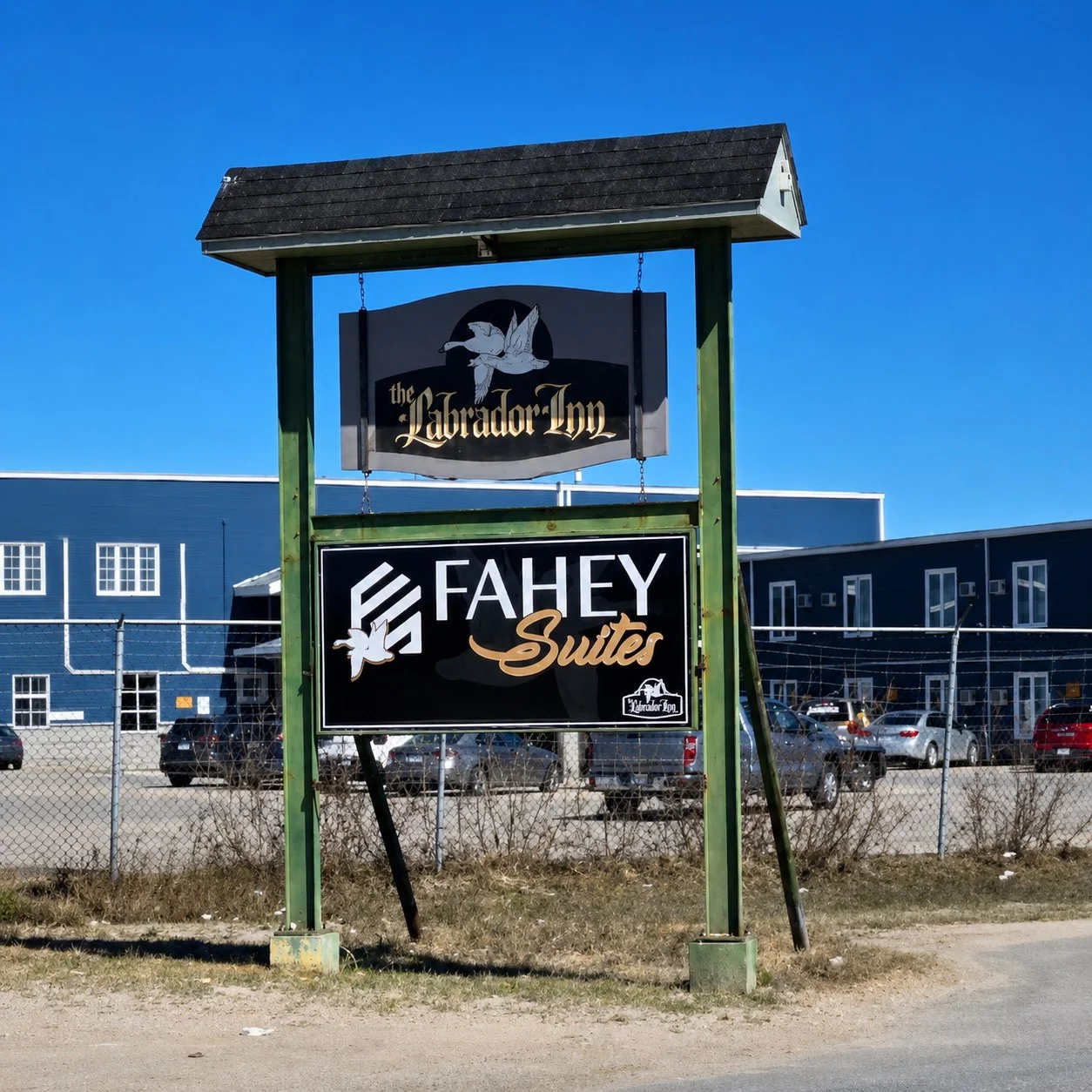 Fahey Suites and The Labrador Inn signage against blue sky
