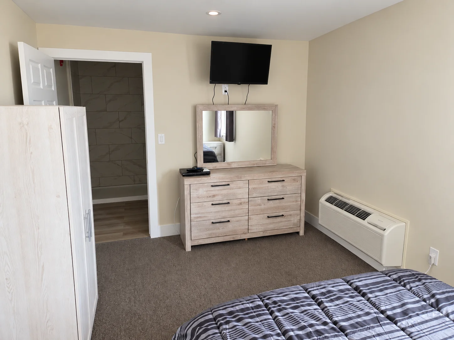 Guest room with dresser and TV