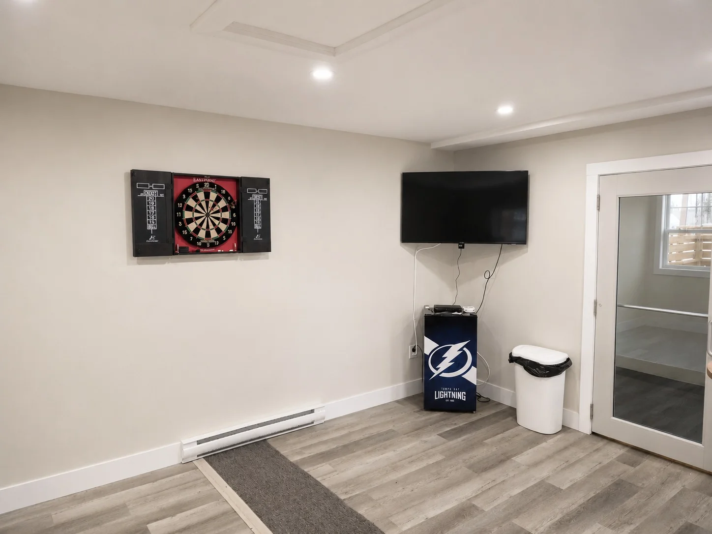 Rec room dartboard and TV wall