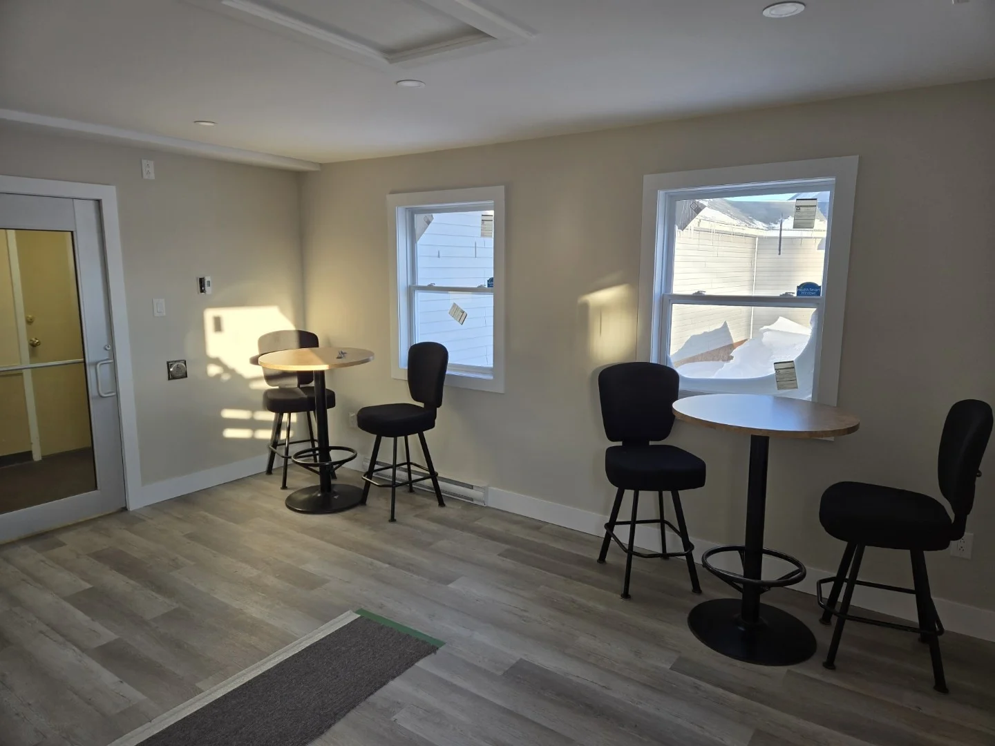 Rec room with bar-height tables and natural light